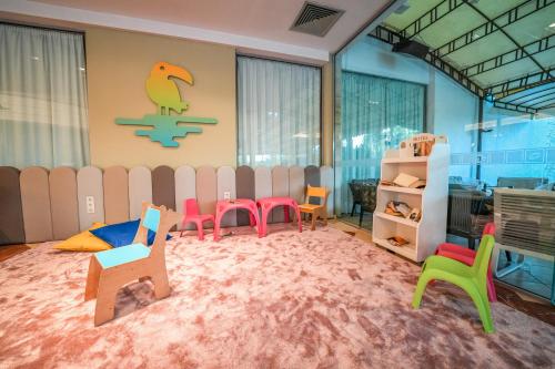 a room with colorful chairs and a play area at Calimera Ralitsa Superior Hotel - Ultra All Inclusive plus Aquapark in Albena