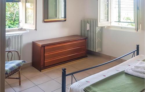 Montorio al VomanoにあるAmazing Home In Montorio Al Vomano With Kitchenのベッドルーム1室(ドレッサー、ベッド1台、窓付)