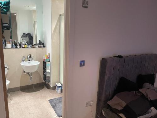 a small bathroom with a sink and a sink at 25 altitude apartments in Croydon