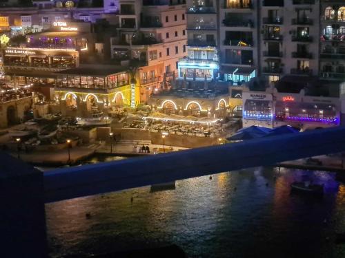 a view of a city at night with lights at St Julians Bay Sea Front Apartments in St Julian's