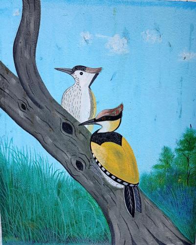 a painting of two birds perched on a tree branch at Tiger Residency Resort in Sauraha
