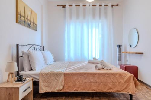 a bedroom with a bed and a large window at Casa de Stella in Limenas