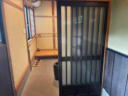 a door in a room with a hallway with stairs at Yamashinobu in Minamioguni