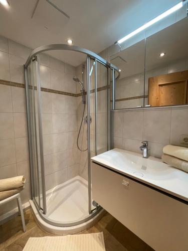 a bathroom with a shower and a sink at Chalet Nina in Reith im Alpbachtal