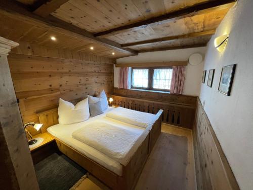 um quarto com uma cama num quarto de madeira em Chalet Nina em Reith im Alpbachtal