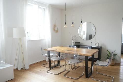 コブレンツにあるDesign Wohnung im Zentrum von Koblenzのダイニングルーム(テーブル、椅子、鏡付)