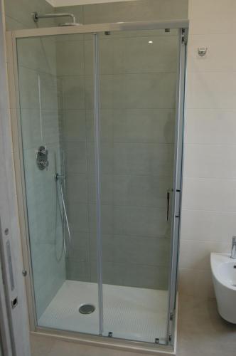 a shower with a glass door in a bathroom at Tenuta Verdolivo in Ostuni