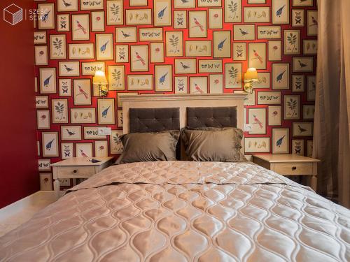 a bedroom with a wall of pictures on the wall at Best Apartments Św. Antoniego in Wrocław