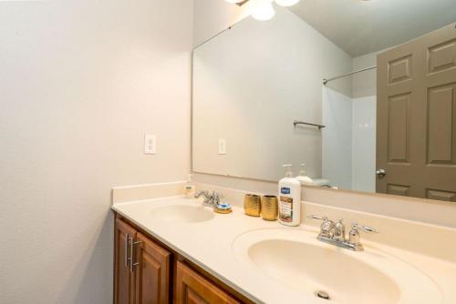 a bathroom with a sink and a large mirror at Lovely 1-Bedroom Keystone in Indianapolis