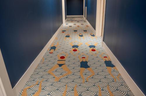 a painting of a group of people on a floor at Ibis Styles Le Touquet in Le Touquet-Paris-Plage