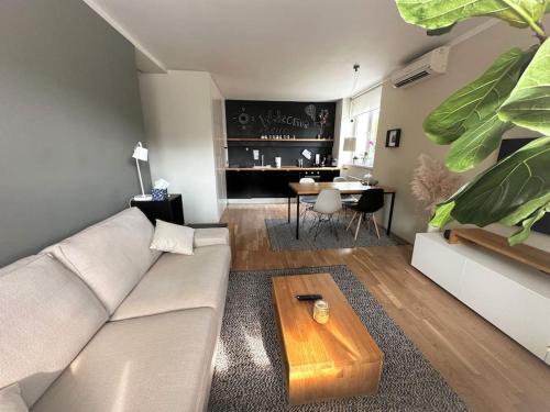 a living room with a couch and a table at Trendy Getaway in Ljubljana