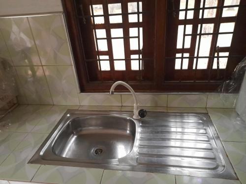 a stainless steel sink in a kitchen with a window at Rosa Kusum Vacation Home Near Kudawa Beach In Kalpitiya in Kalpitiya