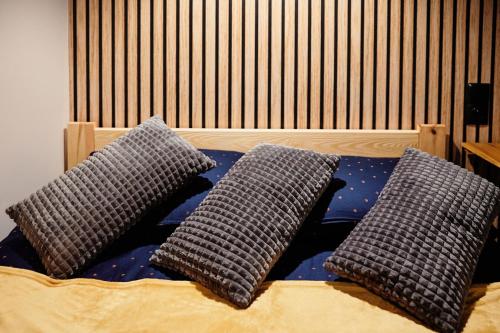a bed with two pillows on top of it at Apartament Incognito Rynek in Tarnobrzeg
