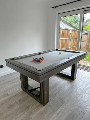 uma mesa de snooker num quarto com em Comfortable Stay in 3 Bed House em Hither Green