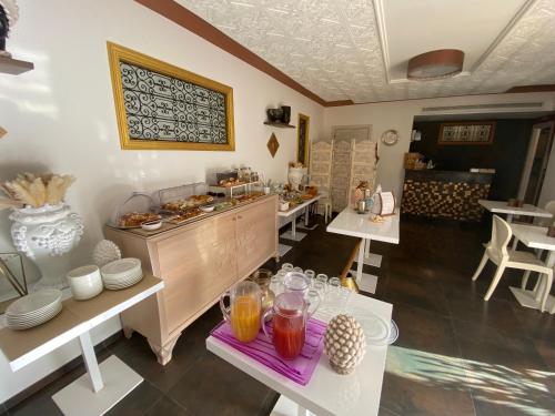 a kitchen with a buffet and tables with drinks at RIAD Comfort Rooms in San Vito lo Capo