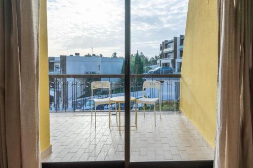 a view of a balcony with a table and chairs at Kubata Hill in Parede