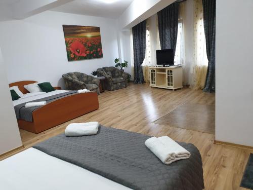 um quarto com uma cama e uma sala de estar em Casa Mary em Costinesti