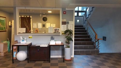 a lobby with a cash register and a staircase at Hotel Jirisan Haetsal in Gurye