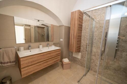 a bathroom with a sink and a shower at CASA ALEF in Manduria