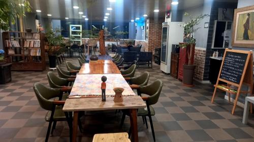 a long table in a room with chairs and a sign at Hotel Jirisan Haetsal in Gurye