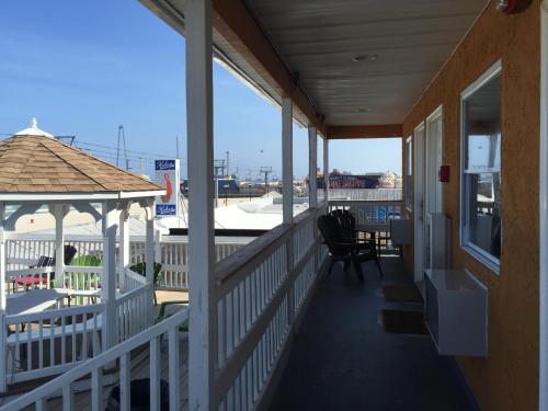 a porch of a house with a gazebo at Boardwalk Hotel Charlee & Apartments Beach Hotel Oceanfront in Seaside Heights