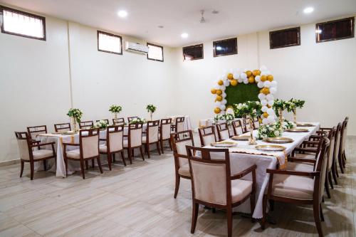 a banquet hall with tables and chairs with flowers at Royal Palace Hotel in Juba