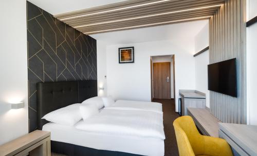 a hotel room with a bed and a tv at Hunguest Helios Hévíz in Hévíz