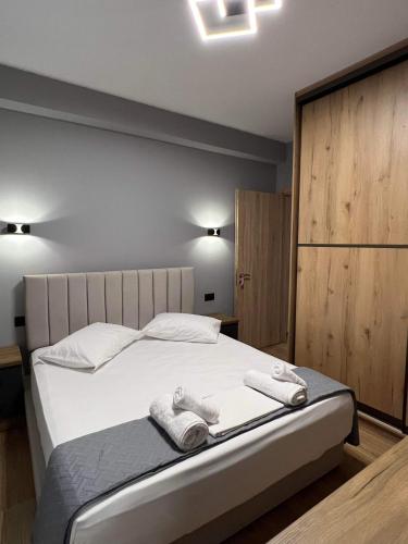 a bedroom with a bed with two towels on it at Ora House in Ayia Evfimia