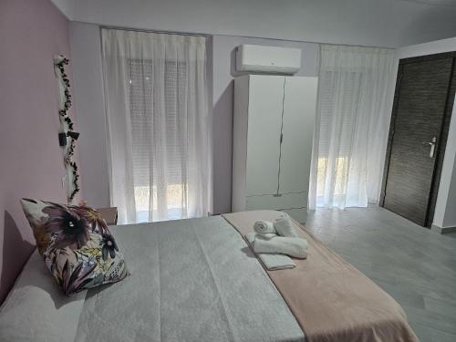 a bedroom with a large bed with two towels on it at Hostal Pompeya Merida in Merida