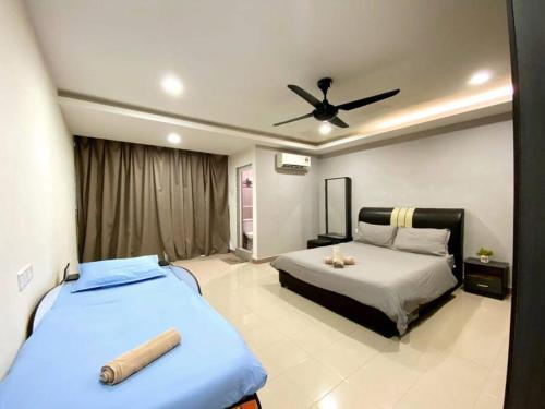 a bedroom with two beds and a ceiling fan at Modern Stylish Double Storey 5Room 9Pax @Icon city in Bukit Mertajam
