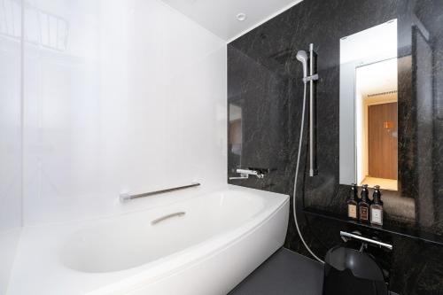 a bathroom with a white sink and a shower at The not Sapporo - Vacation STAY 96538v in Sapporo