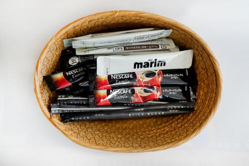 a basket filled withiazepamiazepines and other cigarettes at Kameari 911 Budget Stay High Floor Near Station Mall Disney Access in Tokyo