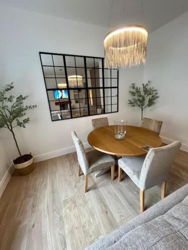 a dining room with a wooden table and chairs at Coastal Apartments No 1 in Seaham