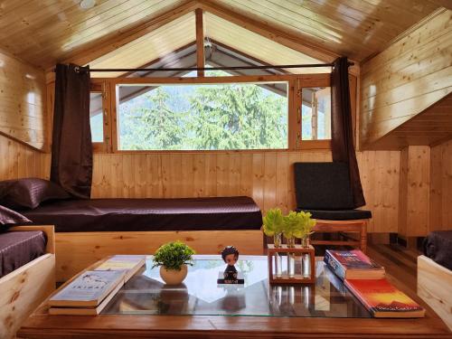 a living room with a couch and a table at Timberwolves in Manāli