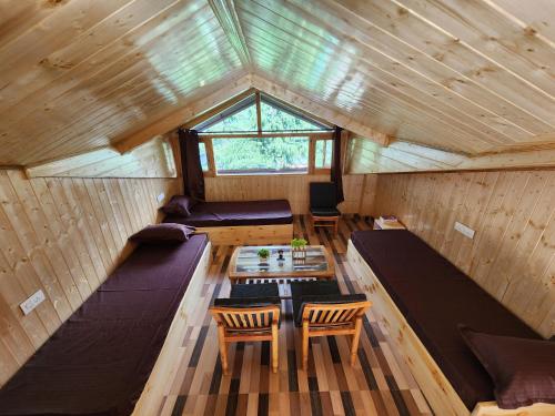 an overhead view of a tiny house with a table at Timberwolves in Manāli