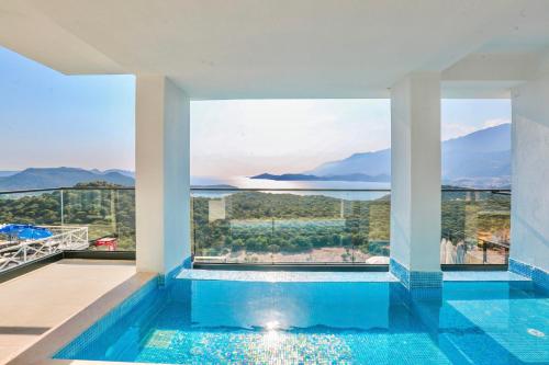 a swimming pool with a view of the water and mountains at Stonehillkaş in Kas