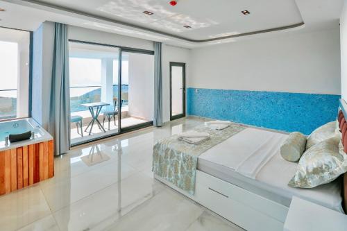 a bedroom with a large bed with a blue headboard at Stonehillkaş in Kas