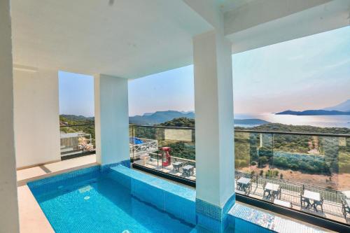 a swimming pool with a view of the ocean at Stonehillkaş in Kas