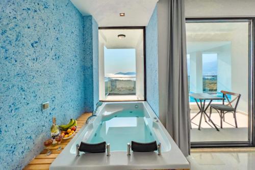 a bathroom with a bath tub in a room with blue walls at Stonehillkaş in Kas