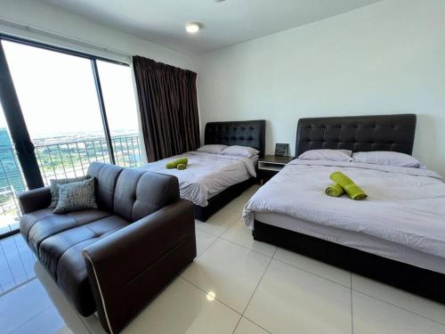 a hotel room with two beds and a couch at Sweet Home at Trefoil Setia Alam in Shah Alam