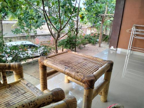 a wooden bench sitting on top of a floor at Fullmoon homestay in Kuta Lombok