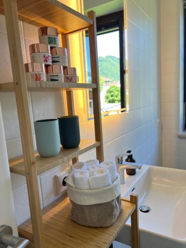 a bathroom with a sink and a counter with towels at Lakeside Traunsee Apartment in Altmünster