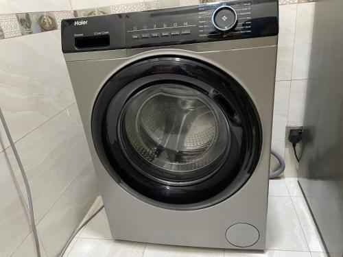 a washer and dryer in a small room at CityLights - Mayfair Signature Collection Gulshan in Dhaka