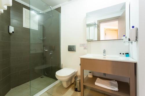 a bathroom with a toilet and a shower and a sink at Bodrum Seaside Beach Club in Bodrum City