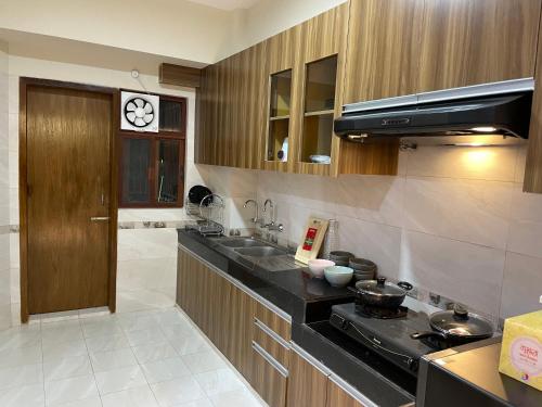 達卡的住宿－Gulshan Stylish 3 bedroom Luxury Apartment in Prime location，厨房配有水槽和炉灶 顶部烤箱