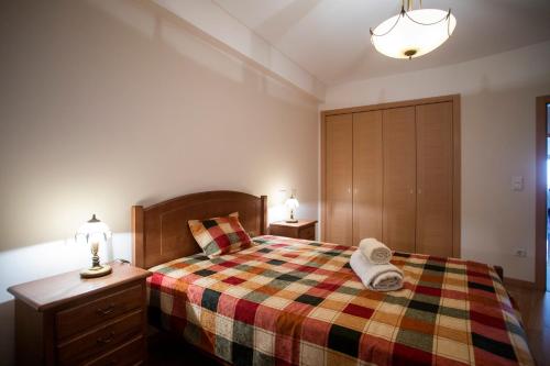 a bedroom with a bed with a colorful blanket at Santa Clara Residence in Lisbon