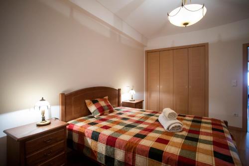 a bedroom with a bed with a colorful blanket at Santa Clara Residence in Lisbon