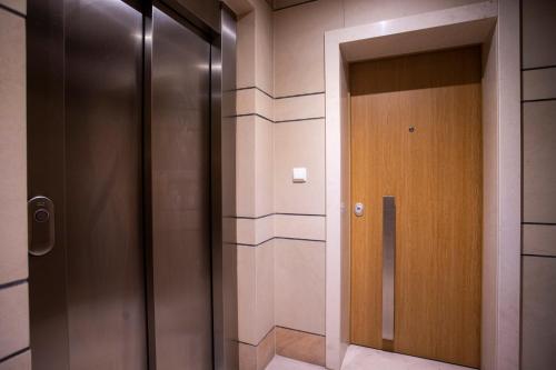 a hallway with a wooden door in a building at Santa Clara Residence in Lisbon