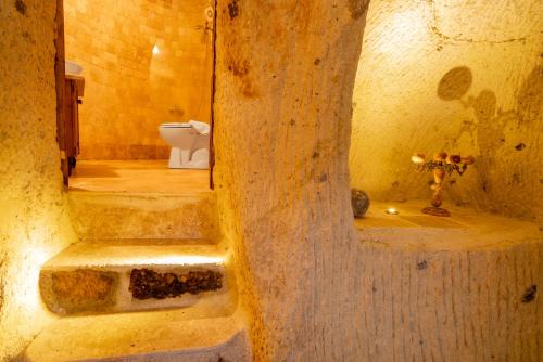 a bathroom with a toilet and stairs in a building at Atilla's Cave Hotel in Nevsehir