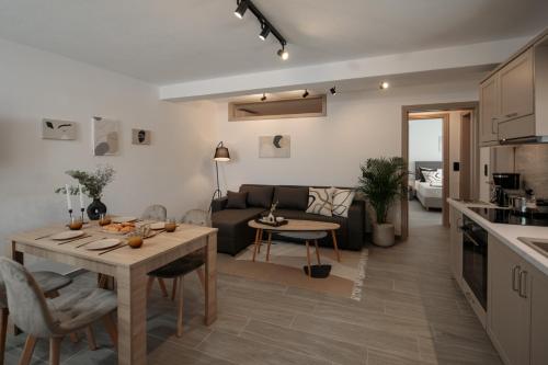 a kitchen and living room with a table and a couch at Jannas Apartments Naxos in Naxos Chora